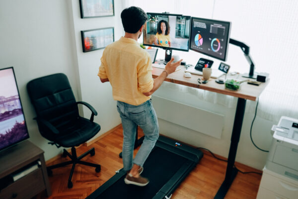 Man At Standing Desk Home Office Talking On Business Video Call