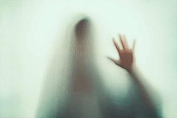 Shadow Of Scary Paranormal Ghost Horror Woman In Soft Focus. Blurry Hand And Body Figure Abstraction