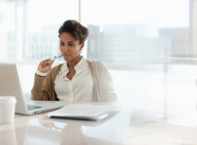 Businesswoman Using Laptop In Office