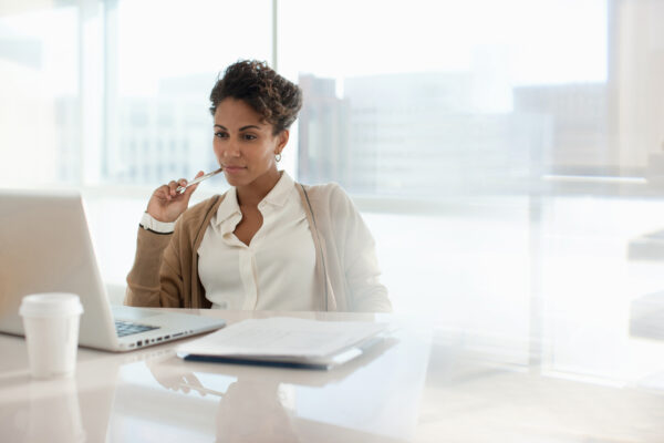 Businesswoman Using Laptop In Office