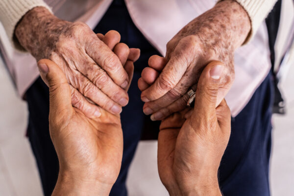 Close Up Of A Caregiver Holding Hands Senior Woman Patient