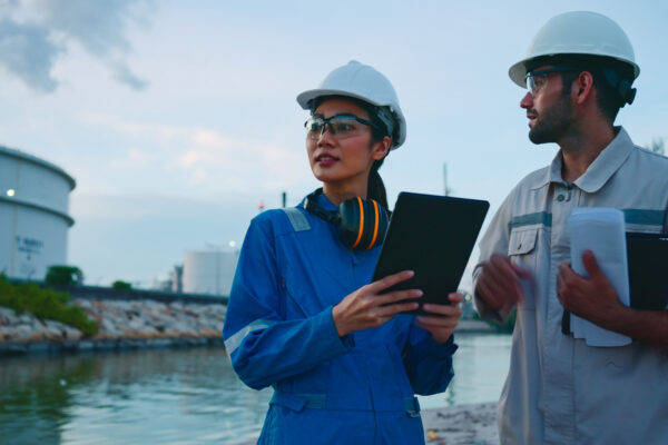 Team Inspection Engineers Working With Laptop Of Oil Factory And Gas Refinery Plant Industry At Night For Inspector Safety Quality Control.