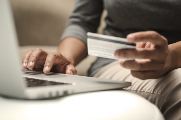 Internet Shopper Entering Credit Card Information Using Laptop Keyboard
