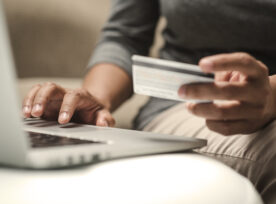 Internet Shopper Entering Credit Card Information Using Laptop Keyboard