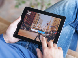 Man holding iPad with App LinkedIn on the screen stock photo