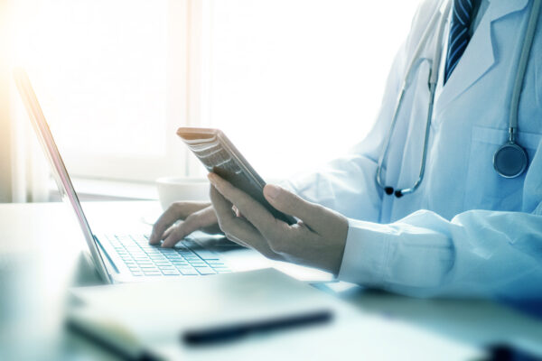 Doctor Using Smartphone In Office