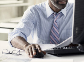 African American Man At Desktop Computer In Office