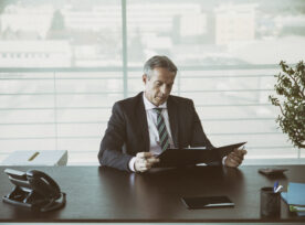 Businessman In His Office Reading A Contract