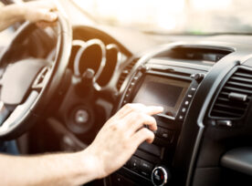 Man Using Navigation System While Driving Car