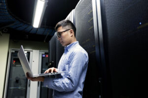 Young It Engineer Inspecting Data Center Servers