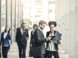 Business People Standing In Street And Discussing