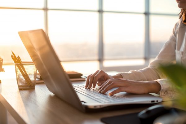 Female Teleworker Texting Using Laptop And Internet, Working Online. Freelancer Typing At Home Office, Workplace.