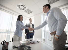 Business People Shaking Hands In Conference Room