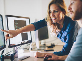 Two people are reviewing medical device marketing content on a computer screen