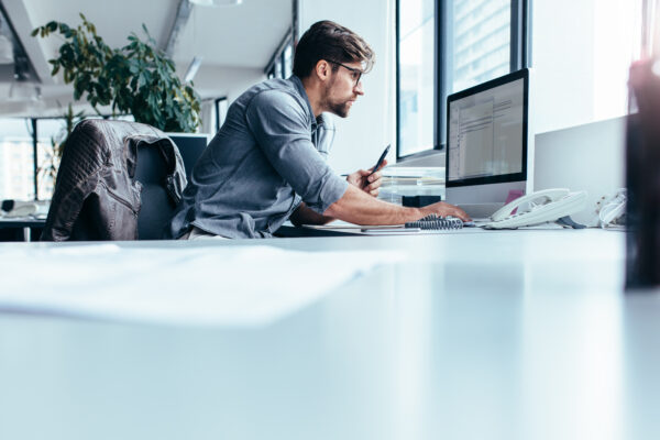 Young Businessman In Office Working On Computer