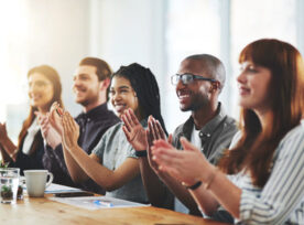 Shot of a group of businesspeople applauding in an office