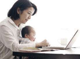 Mother With Baby Working At Home