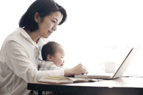 Mother With Baby Working At Home