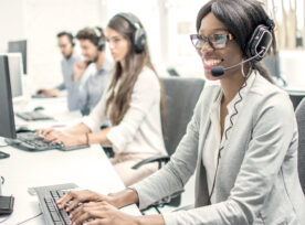 Smiling Young Woman With Headset Working In Call Center.