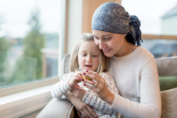 Young Ethnic Mom With Cancer Holds Her Daughter