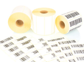 White Label Rolls And Printed Barcodes Isolated On White Background With Shadow Reflection. White Reels Of Labels For Printers. Labels For Direct Thermal Or Thermal Transfer Printing. Barcode Samples.