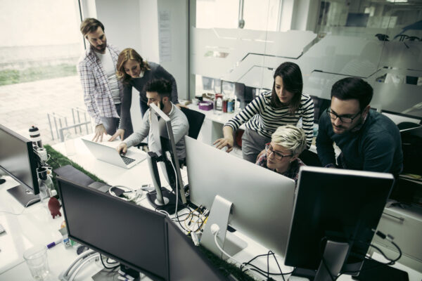 Web Designers Working In Office On Project Together