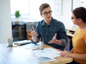 Two people working together at a desk