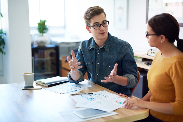 Two people working together at a desk