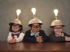 Photo of kids with thinking hats on, unleashing creativity.