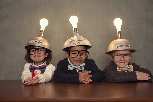 Photo of kids with thinking hats on, unleashing creativity.