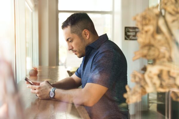 Man on cellphone using embedded finance function