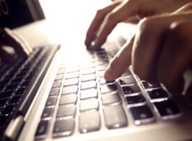 Hands Typing On Laptop Computer