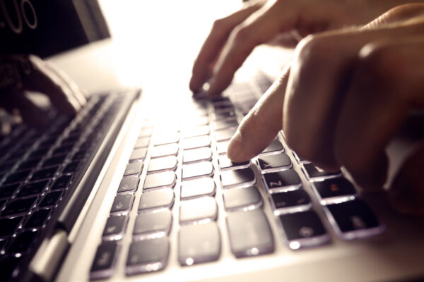 Hands Typing On Laptop Computer