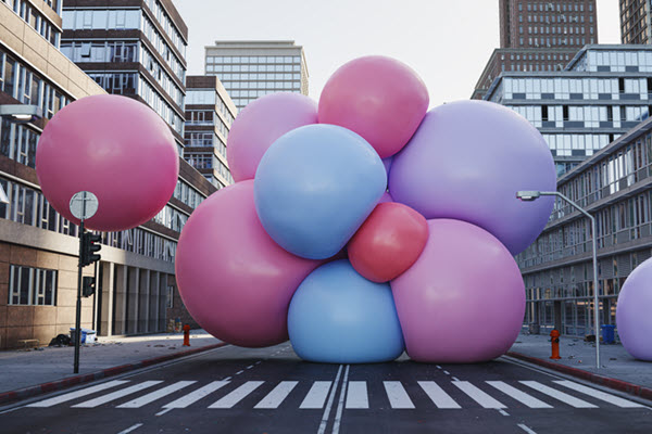Obtrusive balloons blocking a city street.
