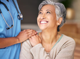 Nurse, Senior Woman And Smile With Comfort, Holding Hands Or Support In Nursing Home For Retirement. Doctor, Medic Or Caregiver With Kindness, Empathy Or Gratitude For Help, Trust Or Service In House