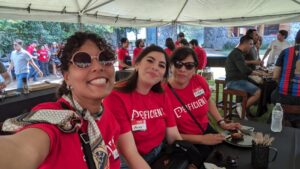 three women sitting together smiling at the camera