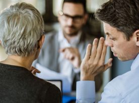 Business Colleagues Whispering On A Meeting In The Office.