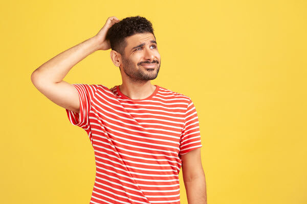 Photo of a man scratching his head. He’s perplexed about a business problem that should be fixed, but not sure how to get the solution approved.