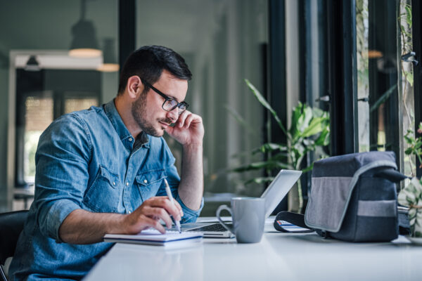 Focused Adult Man, Making A Schedule For Work.