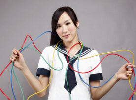 Woman Trying to Manage Multiple Wires Wrapped Around Her – Project Dependencies