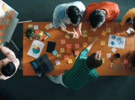 Top-down view of a small group of brainstorming individuals.