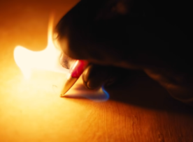 Person writing and fire comes out of the pen