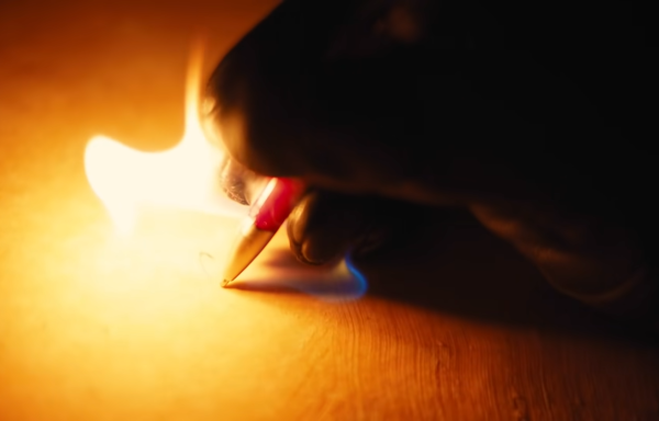 Person writing and fire comes out of the pen