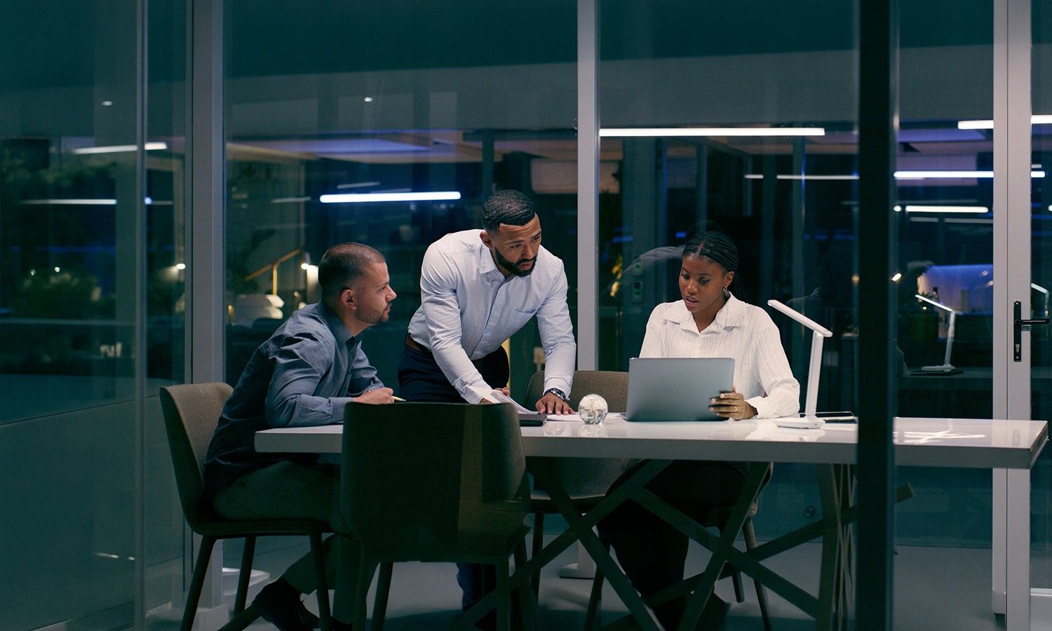 Three Colleagues Working On Laptops For Governed Ai In Banking