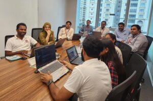 Group of people sitting around a table in an office setting